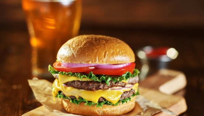 Double cheeseburger with lettuce, tomato, onions at Fifth Avenue Taphouse New Brighton.