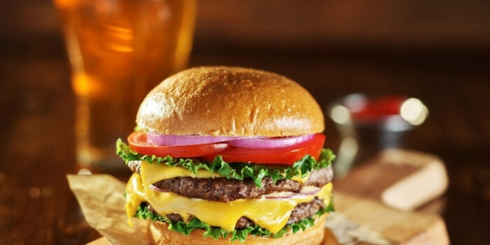 Double cheeseburger with lettuce, tomato, onions at Fifth Avenue Taphouse New Brighton.