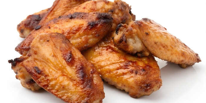 Golden-brown chicken wings from Fifth Avenue Taphouse New Brighton on a white background.