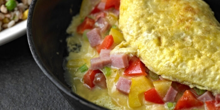 Omelet with ham, peppers, and green onions served skillet-style at Fifth Avenue Taphouse New Brighton.