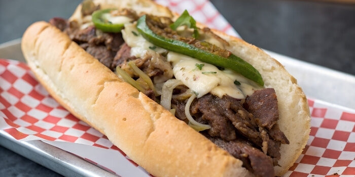 A Philly cheesesteak with melted cheese, onions, and peppers at Fifth Avenue Taphouse New Brighton.