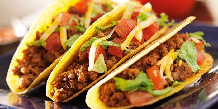 Three hard shell tacos with ground beef, lettuce, and cheese at Fifth Avenue Taphouse New Brighton.